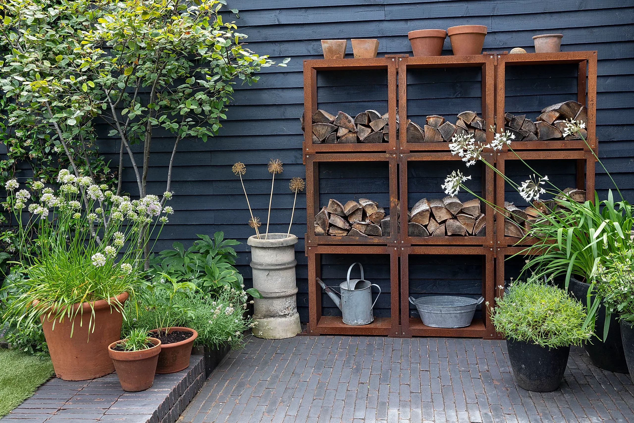 a wood shelves with plants and pots on a patio