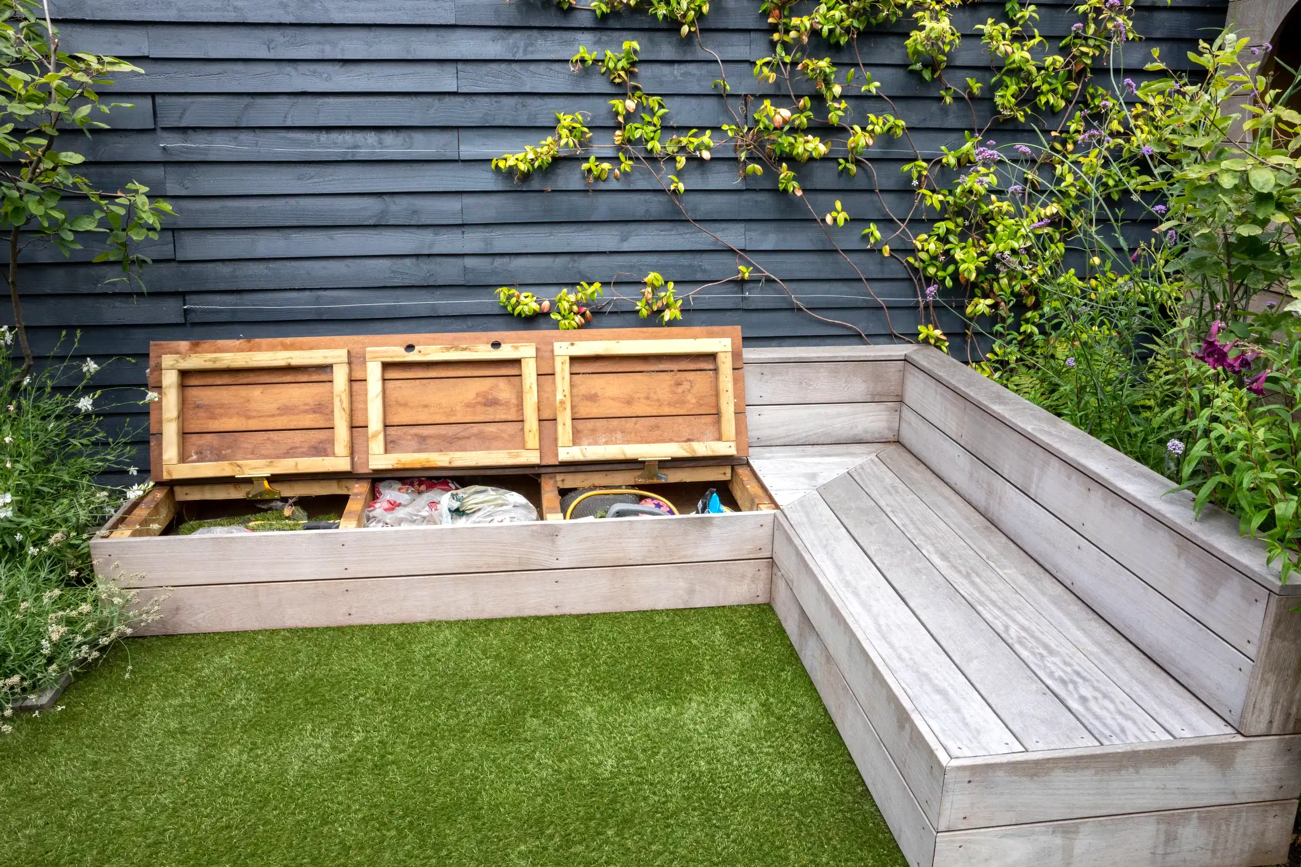 a bench with wooden boxes in front of a wall