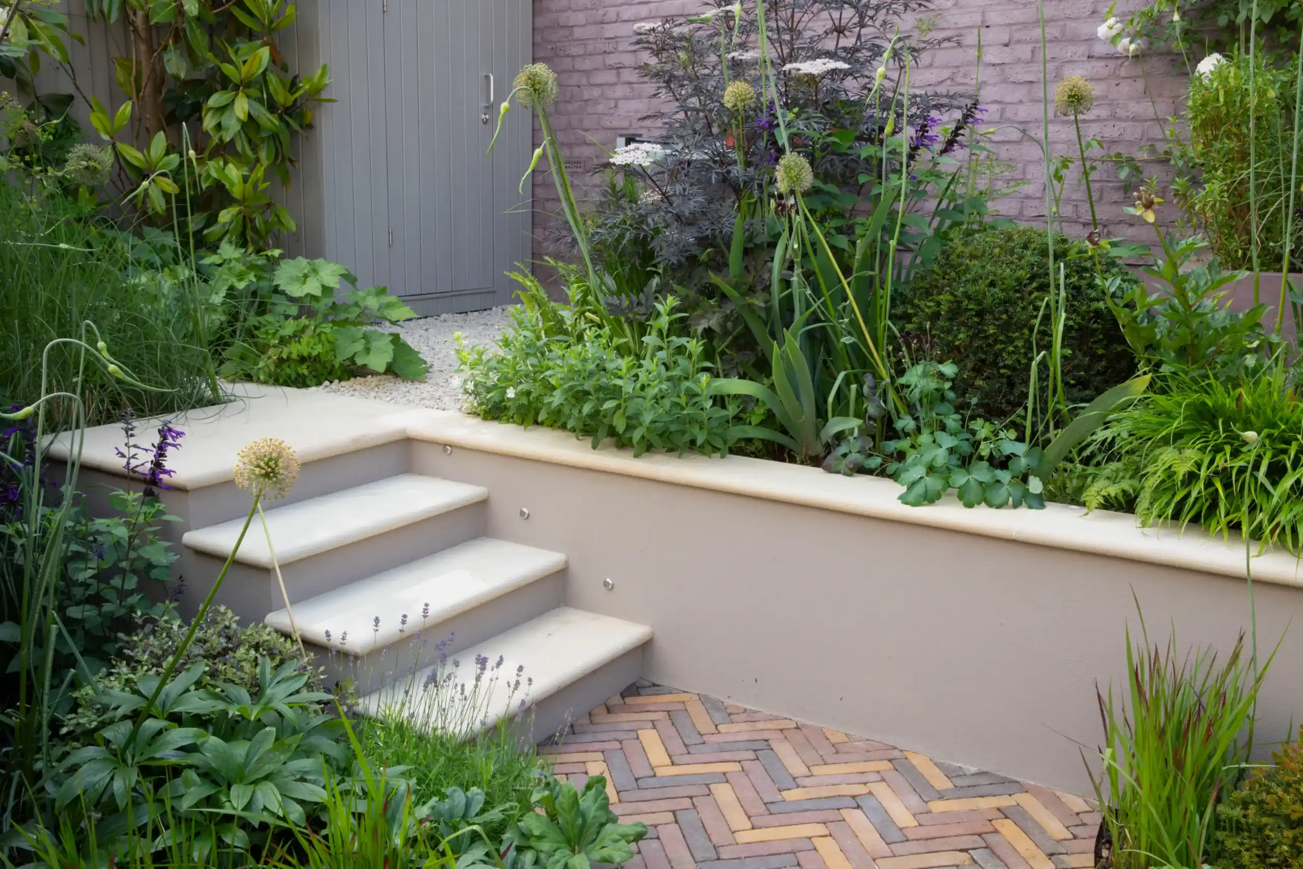 a garden with stairs and plants