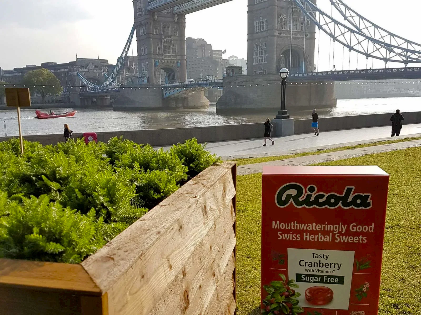 a box of plants next to Tower bridge