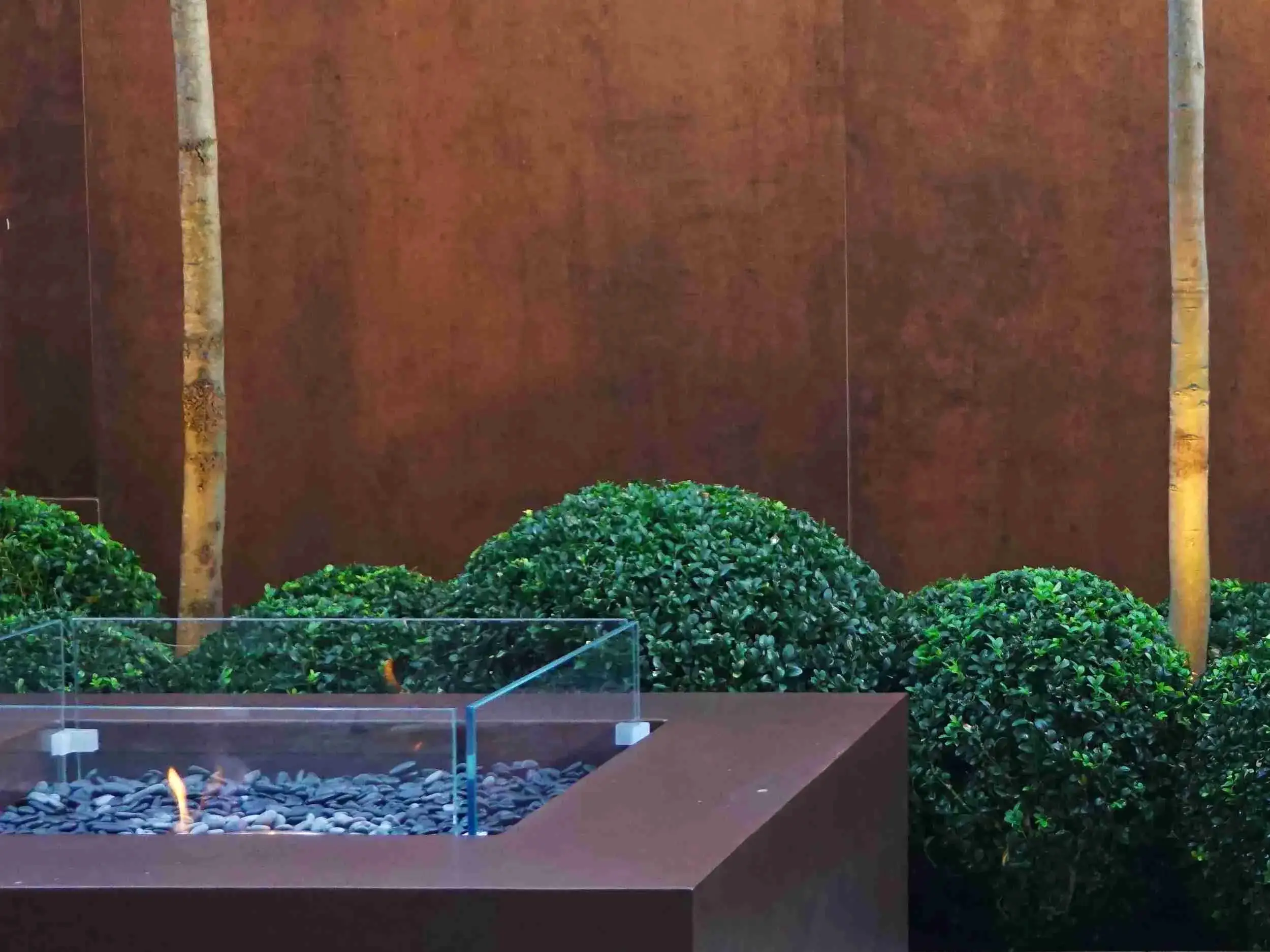 a fire pit with a glass cover and a glass box with rocks