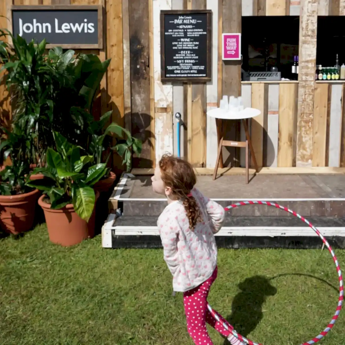 a girl holding a hula hoop outside a building