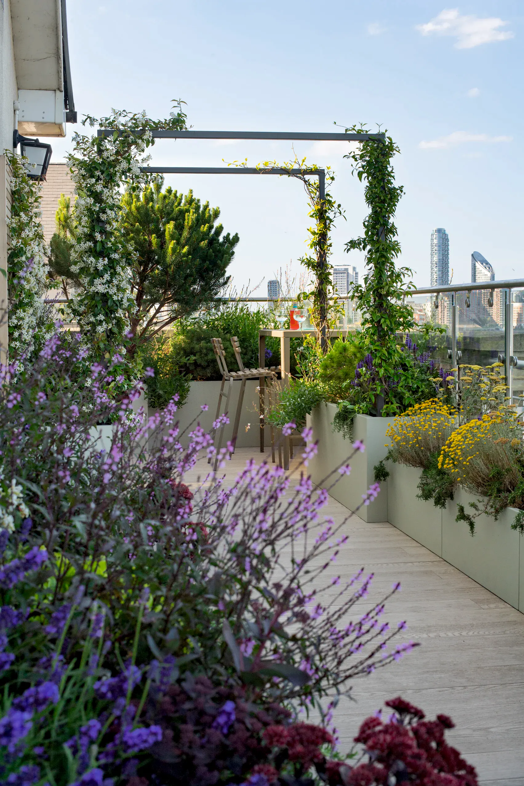 a patio with plants and a bench