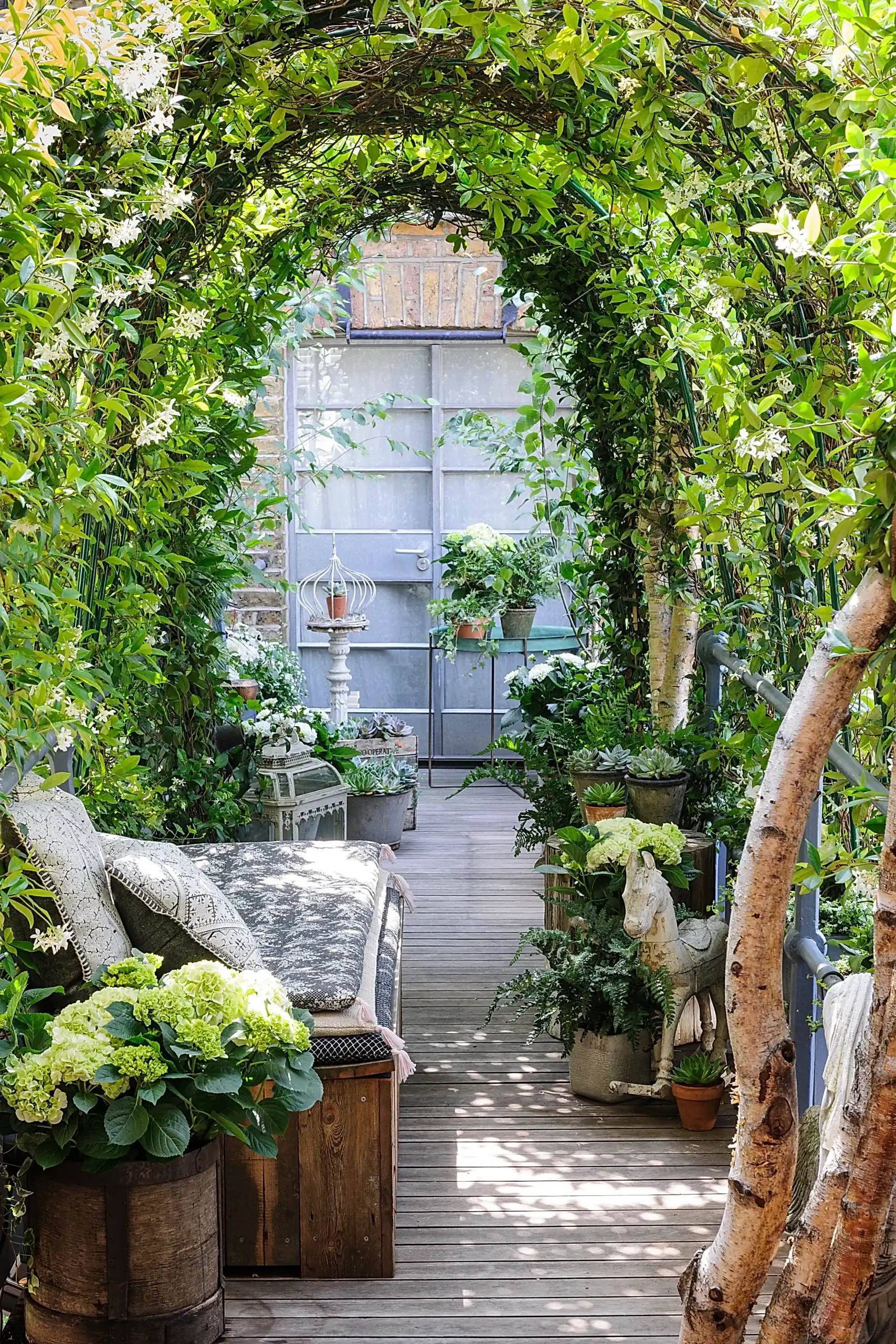 a garden with plants and a bench