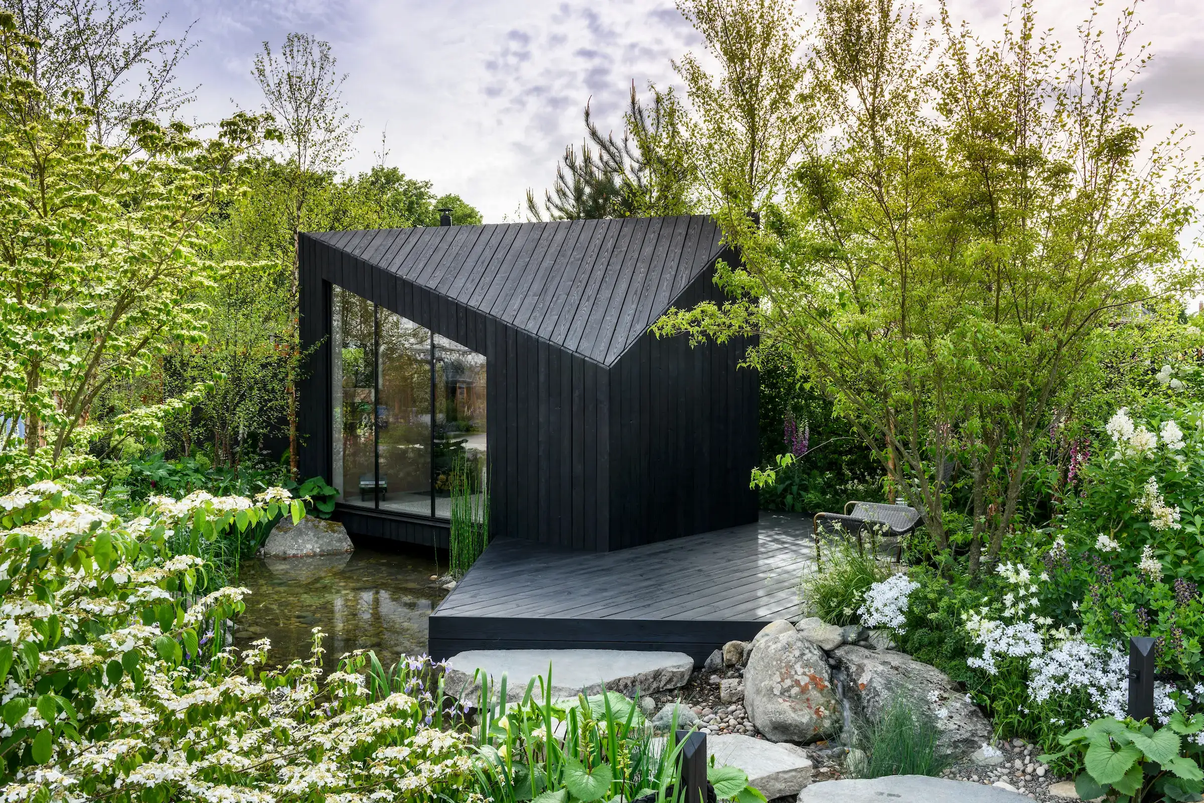 a black building surrounded by trees