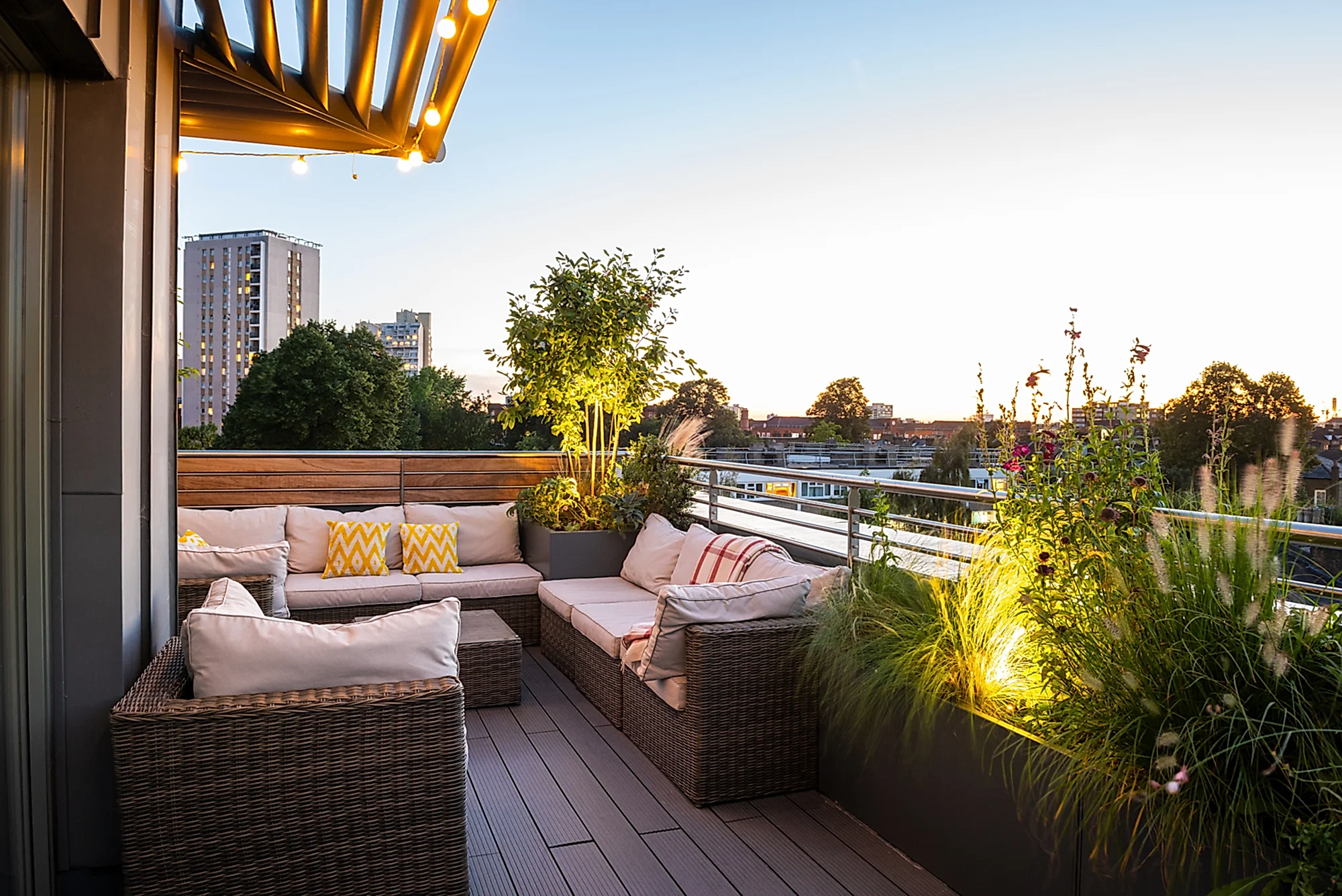 a patio with a planter and a bench