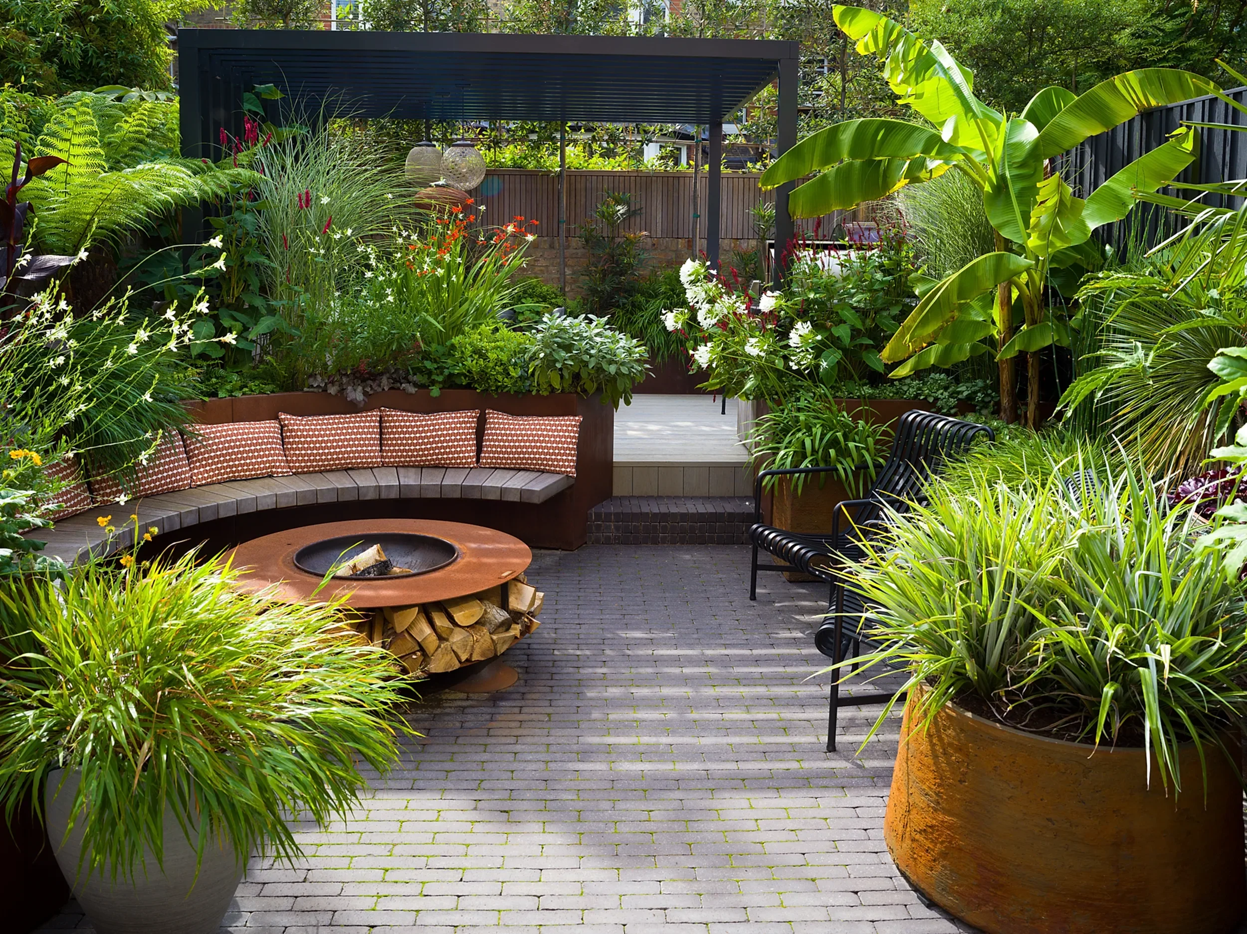 Circular seating in a lush urban oasis garden design in Highbury and Islington