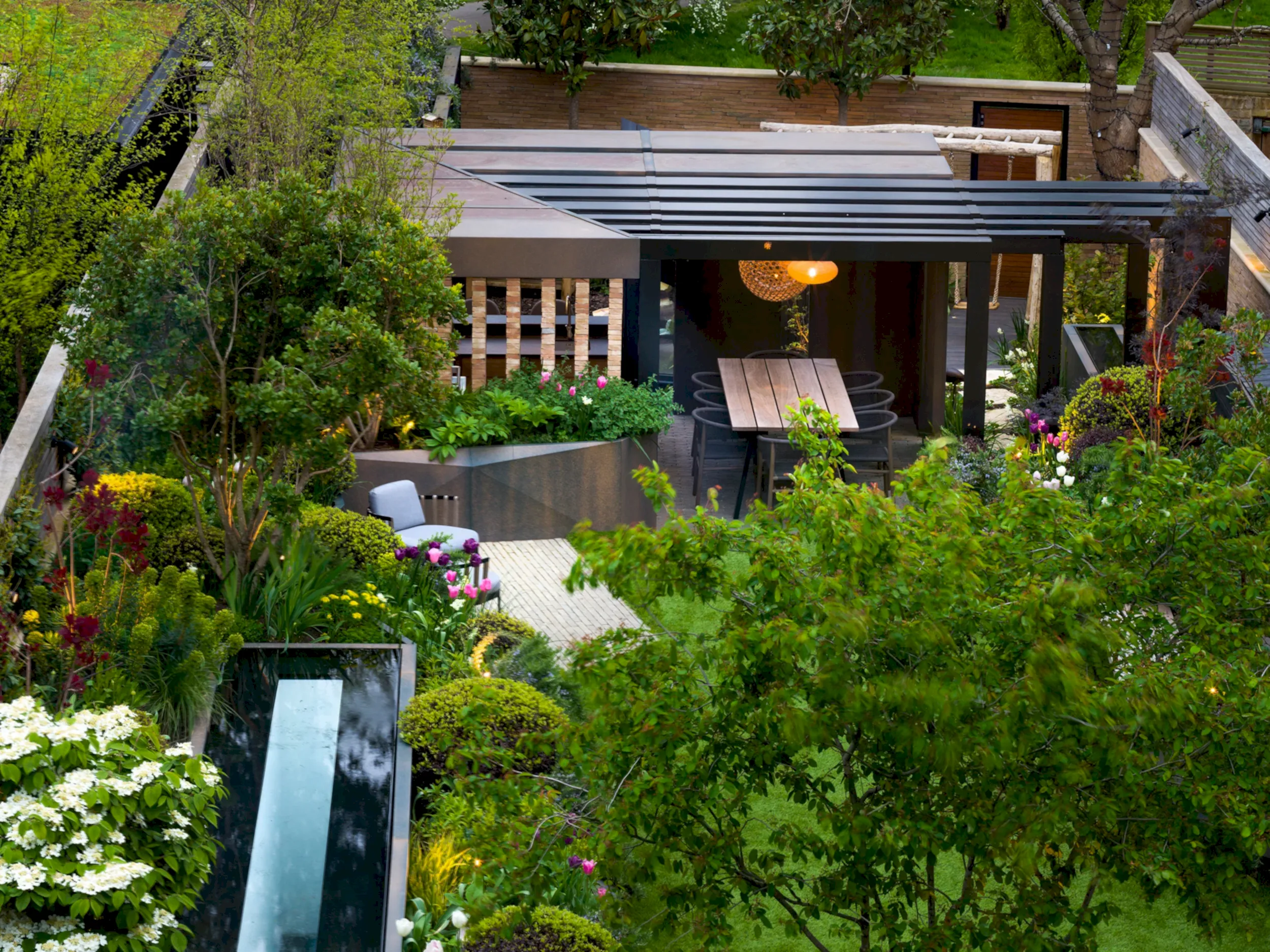 a patio with a table and chairs in a garden