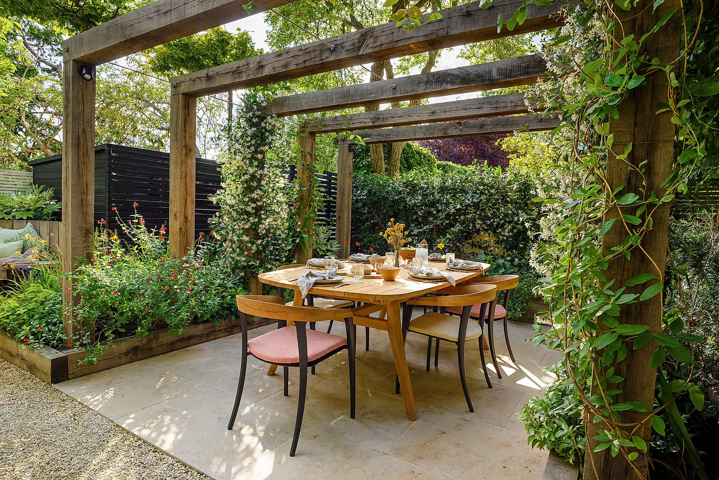 a table and chairs under a pergola