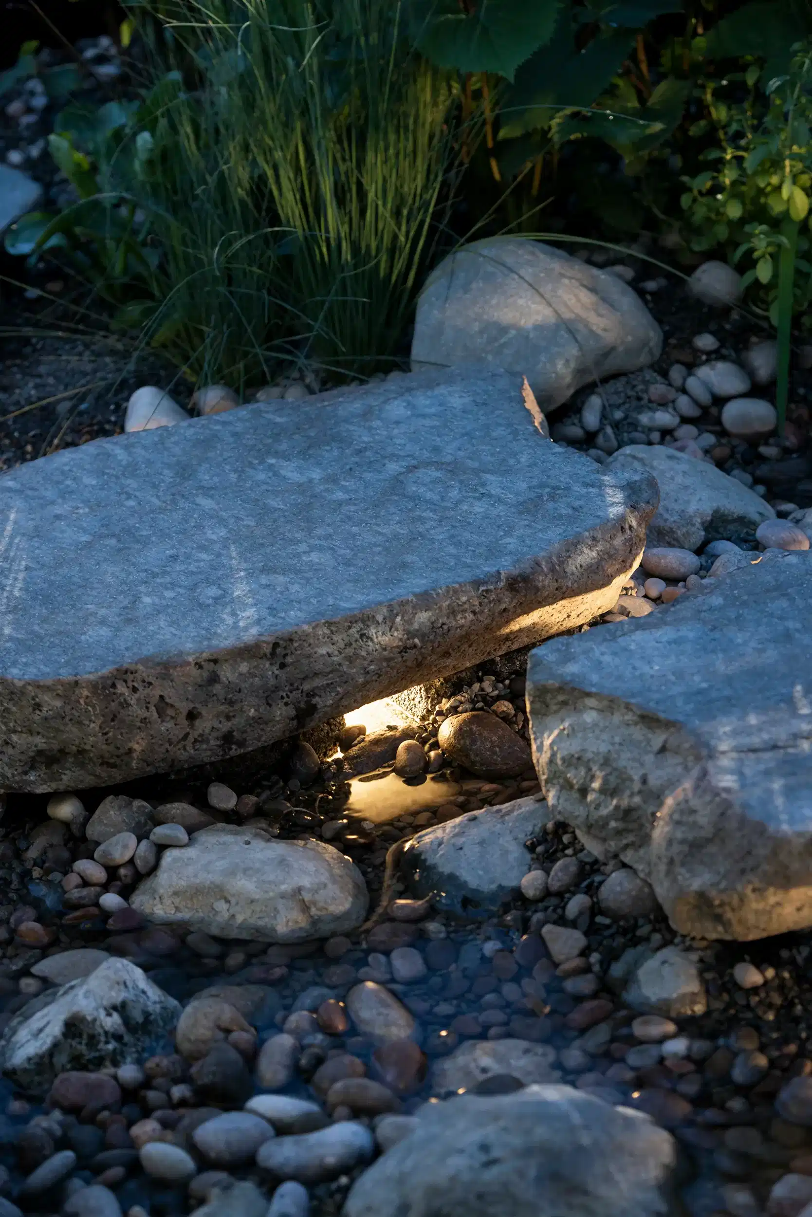 a lit pebble water feature