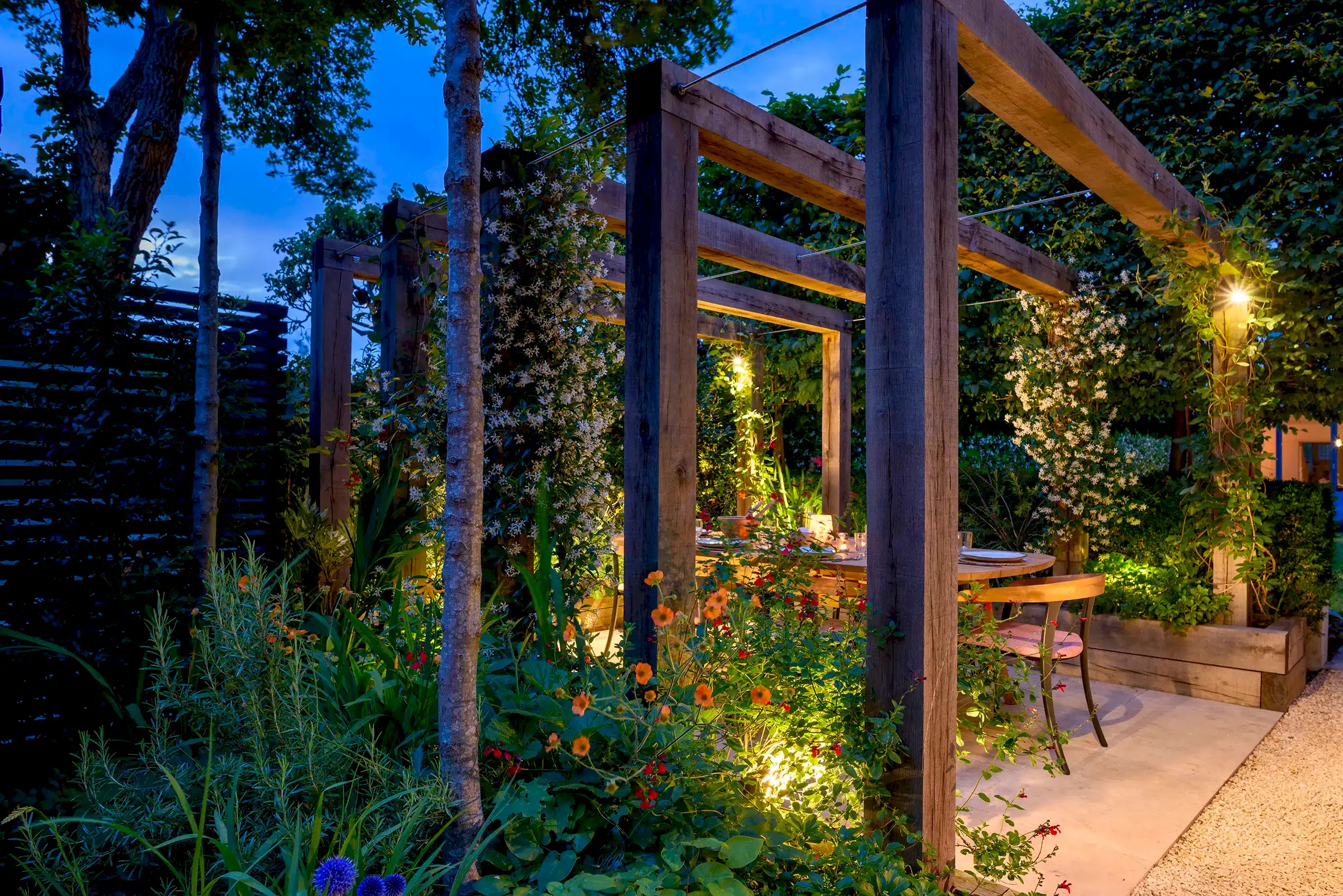 Pergola garden design in a London garden with outdoor dining area and lighting