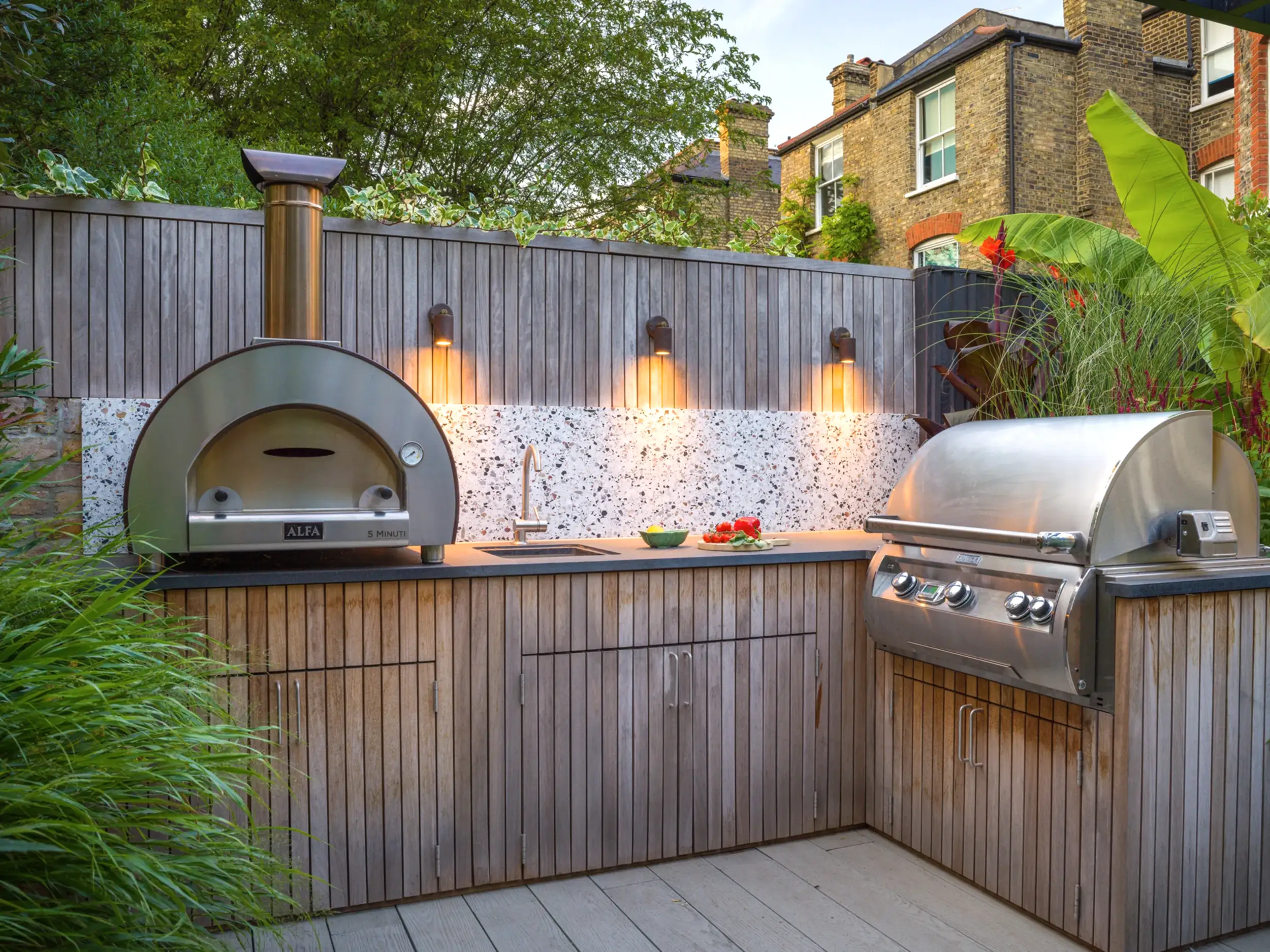 a barbecue grill and oven on a deck