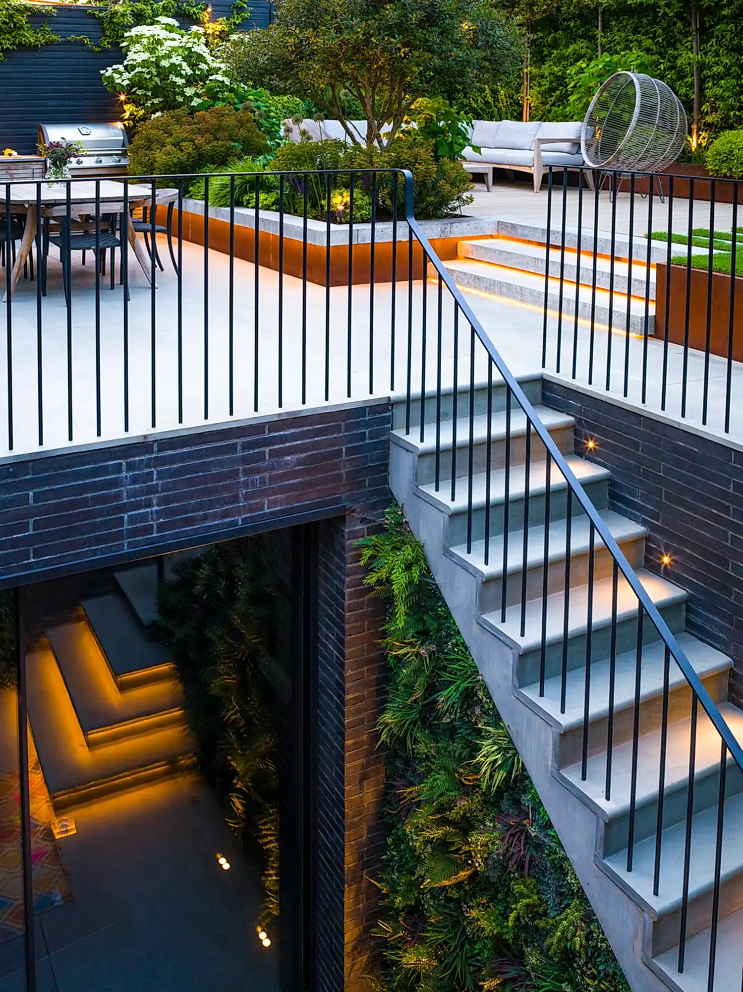 a patio with stairs and plants