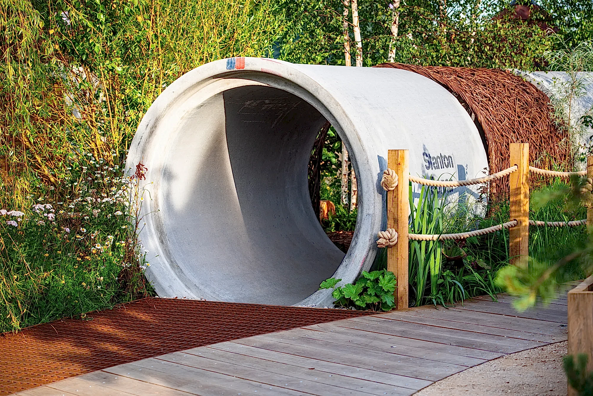 a concrete tunnel with a rope around it