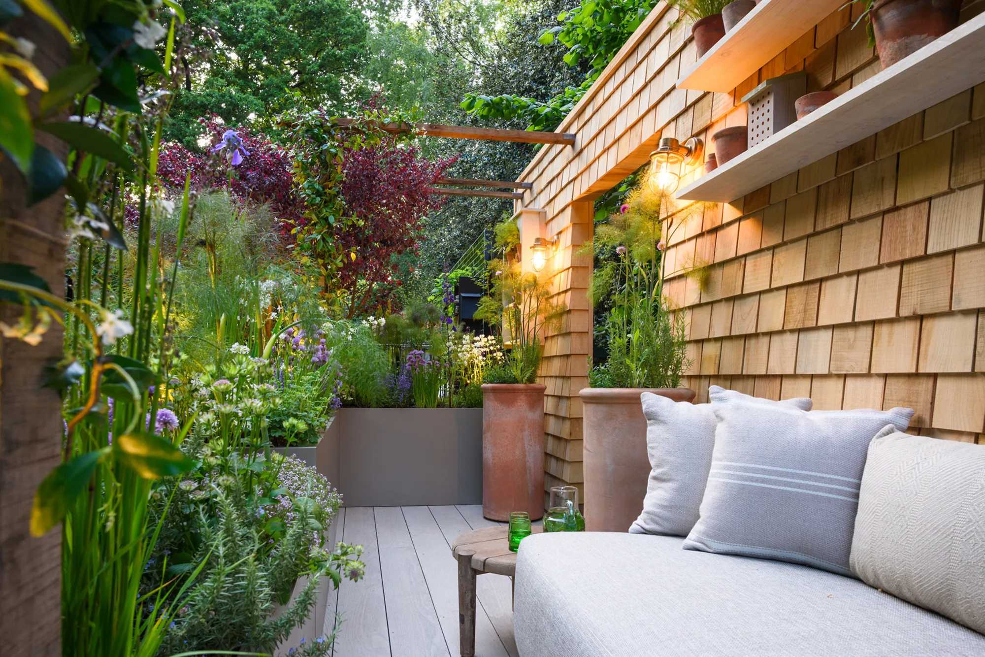 a patio with a couch and plants