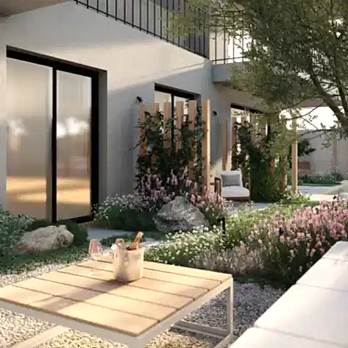 a patio with a table and chairs in front of a building