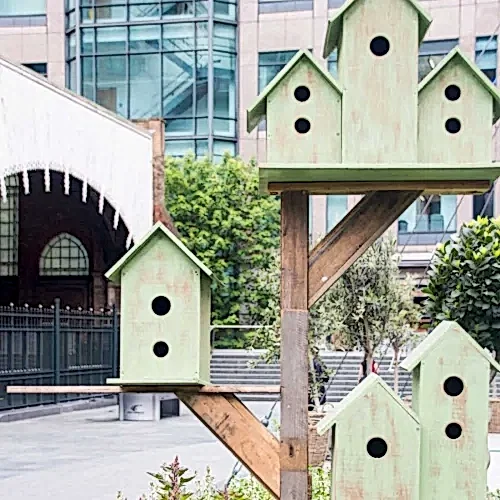 a group of bird houses on a pole