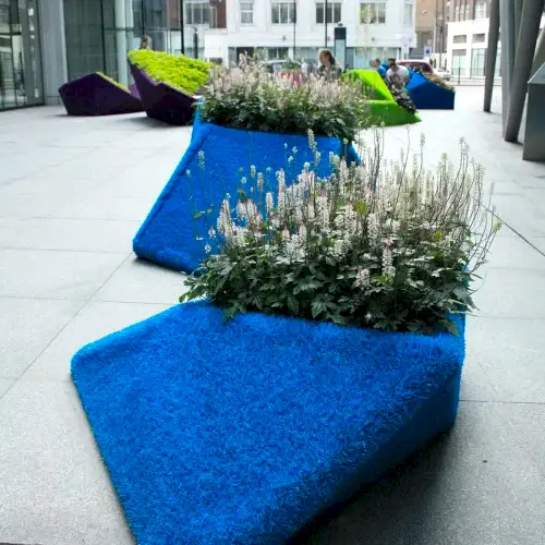 a group of plants in a blue planter