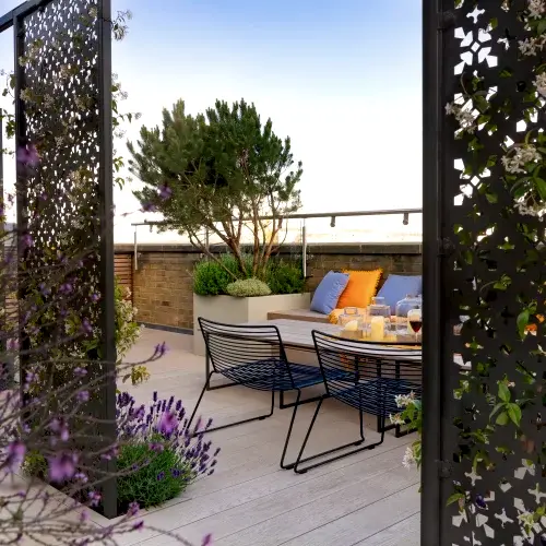 a patio with a table and chairs