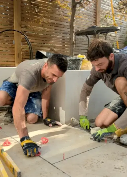 Men laying a slab patio