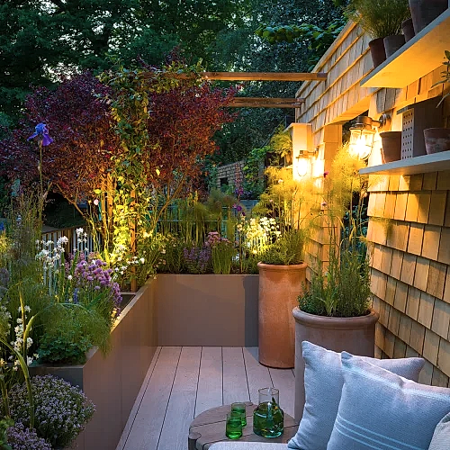 a patio with plants and lights