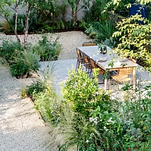 Naturalistic garden design in a London garden with soft planting and a dining table