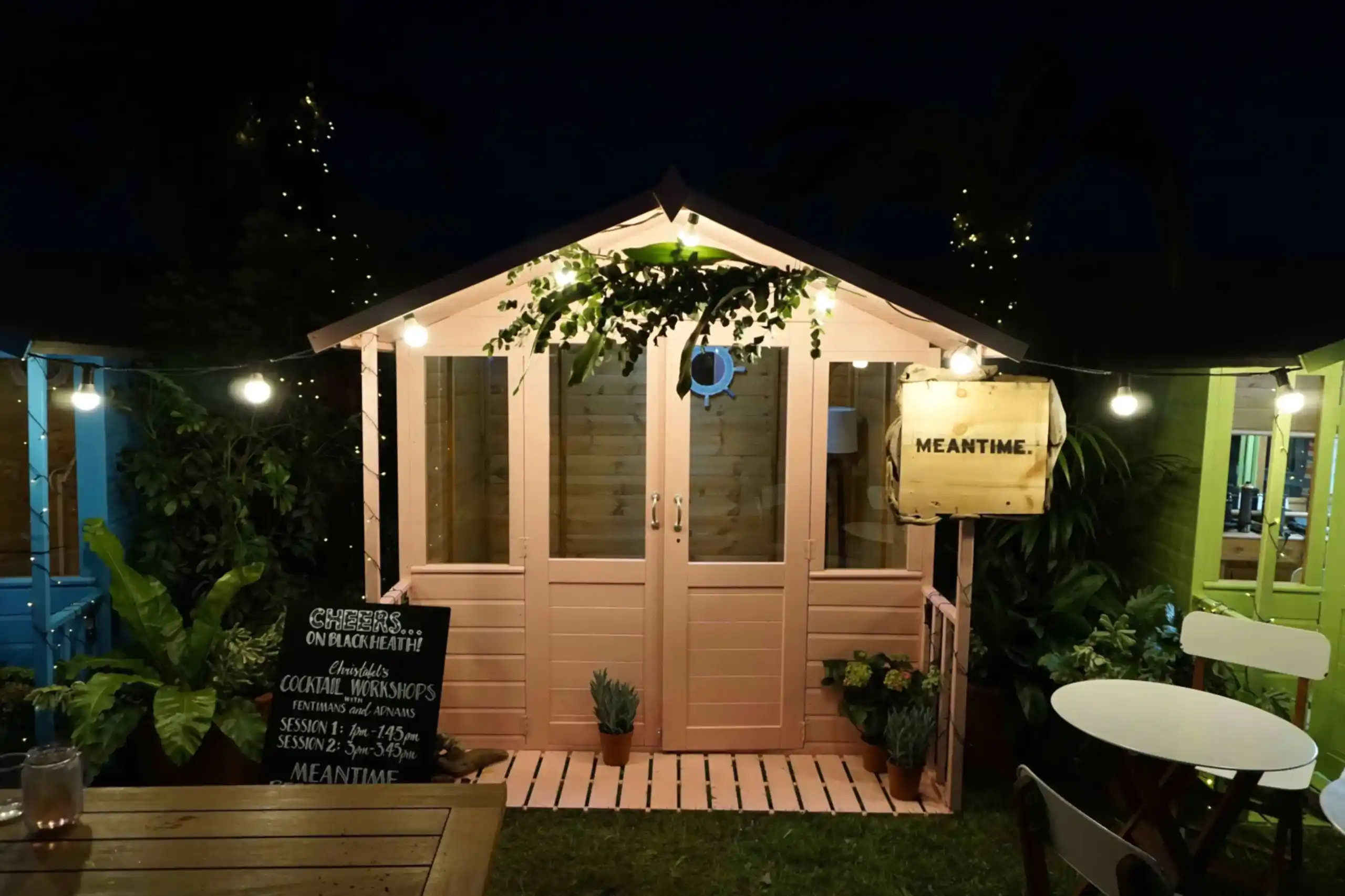 a small shed with lights and a sign