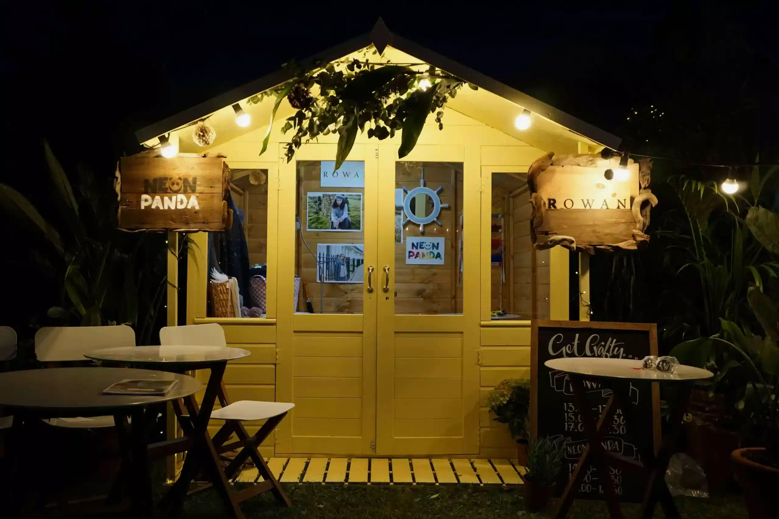 a yellow shed with tables and chairs