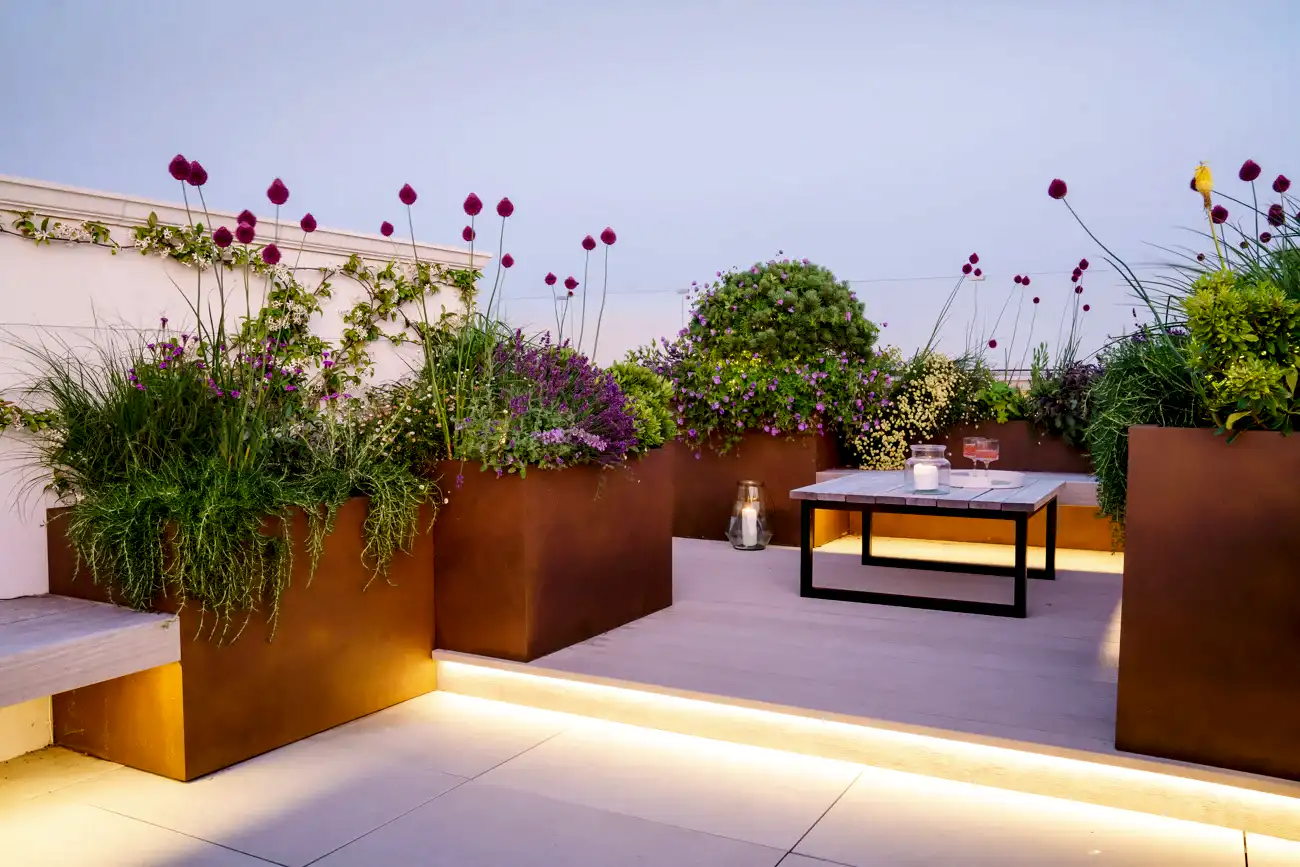 a patio with a table and plants